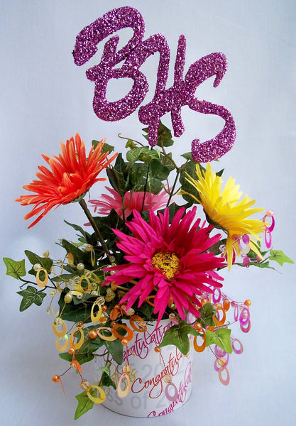 Colorful graduation centerpiece with daisies and school initials