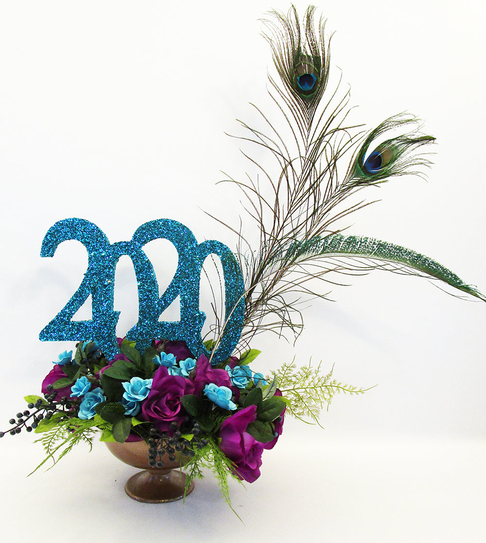 Graduation centerpiece with purple and turquoise flowers & Peacock feathers